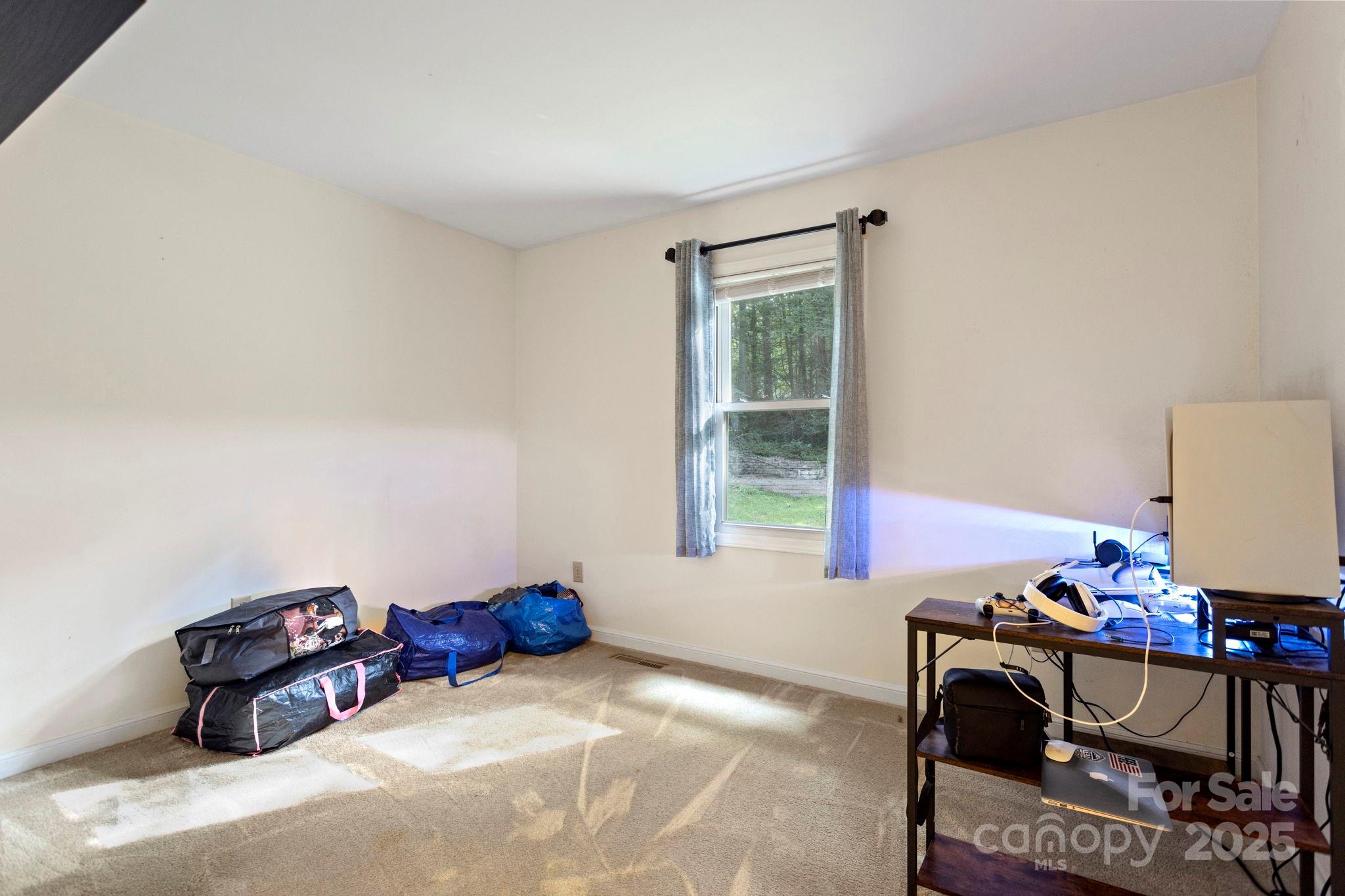 207 Mint Way Flat Rock, NC 28731 - Photo 19 of 27 a bedroom with furniture and window