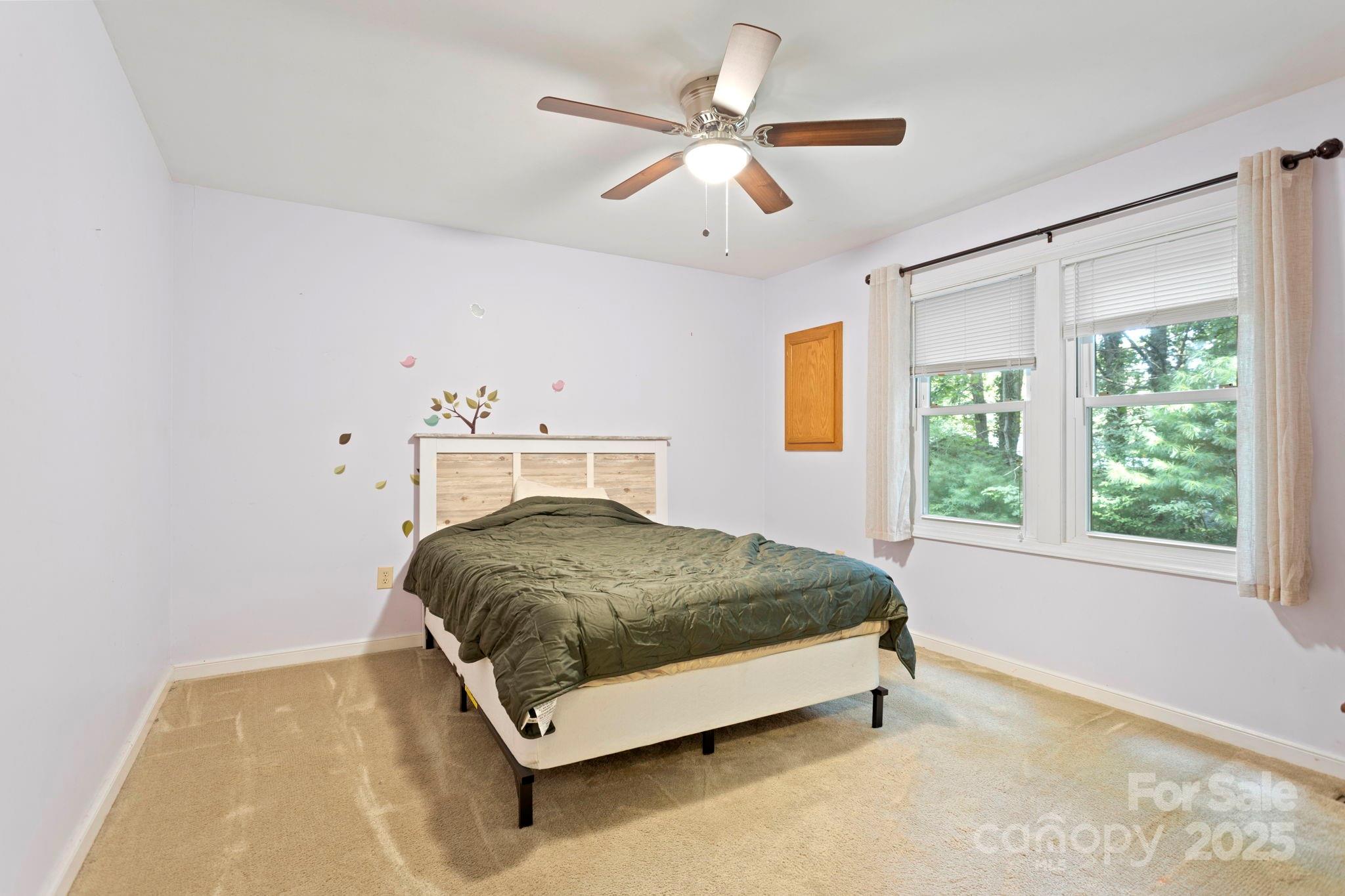 207 Mint Way Flat Rock, NC 28731 - Photo 20 of 27 a spacious bedroom with a bed and window