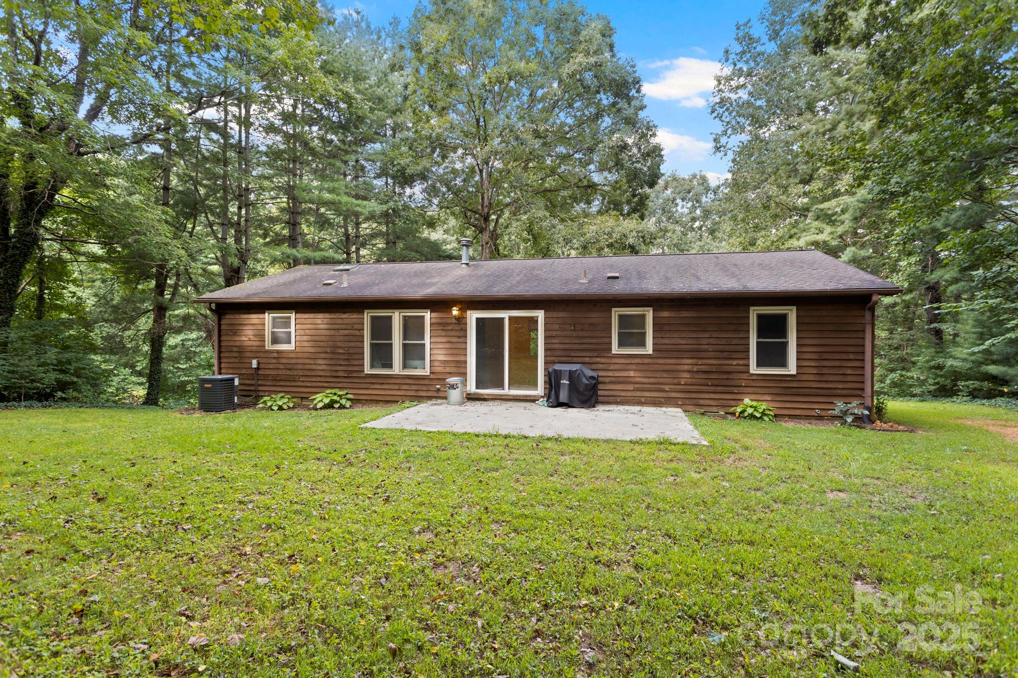 207 Mint Way Flat Rock, NC 28731 - Photo 21 of 27 a front view of a house with a garden