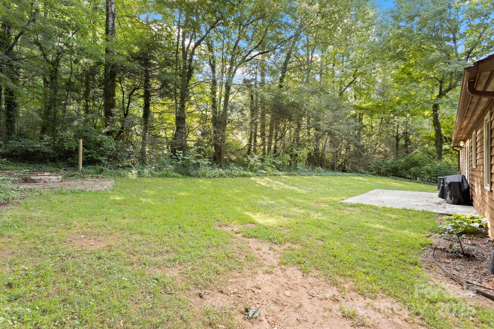 207 Mint Way Flat Rock, NC 28731 - Photo 25 of 27 a view of outdoor space with trees all around