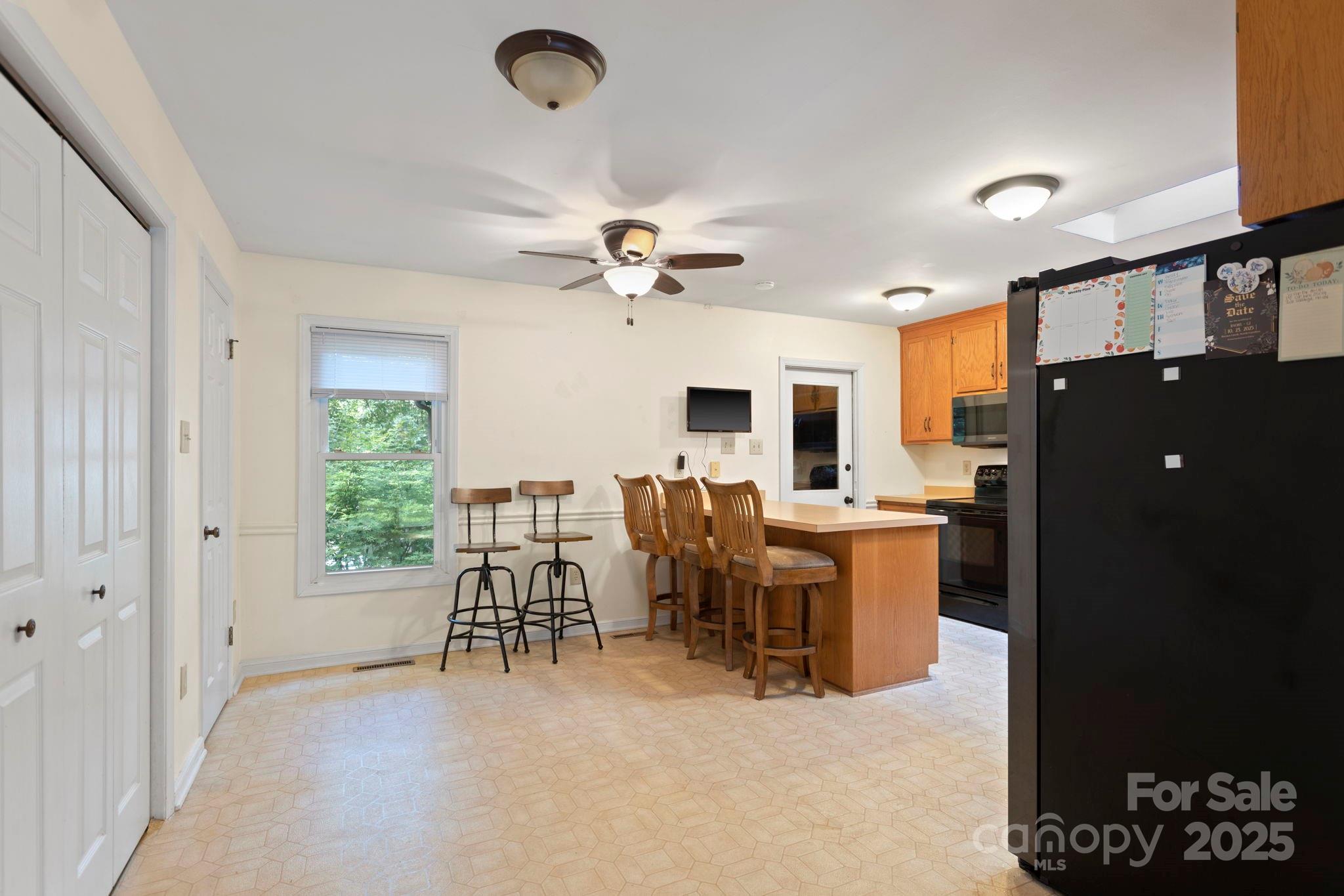 207 Mint Way Flat Rock, NC 28731 - Photo 9 of 27 a view of a dining room with furniture window and wooden floor