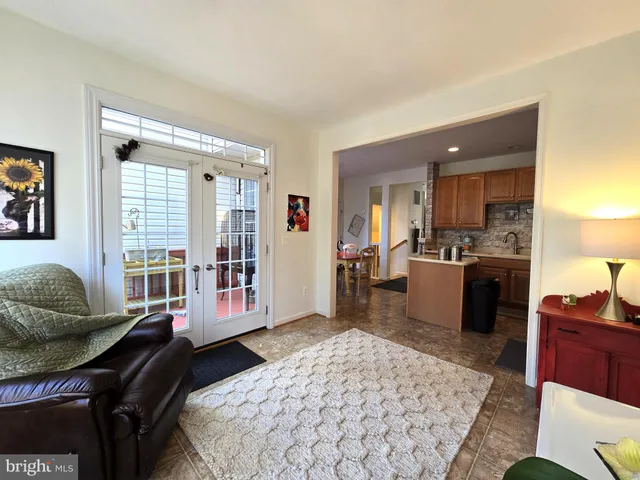 a living room with furniture rug and wooden floor
