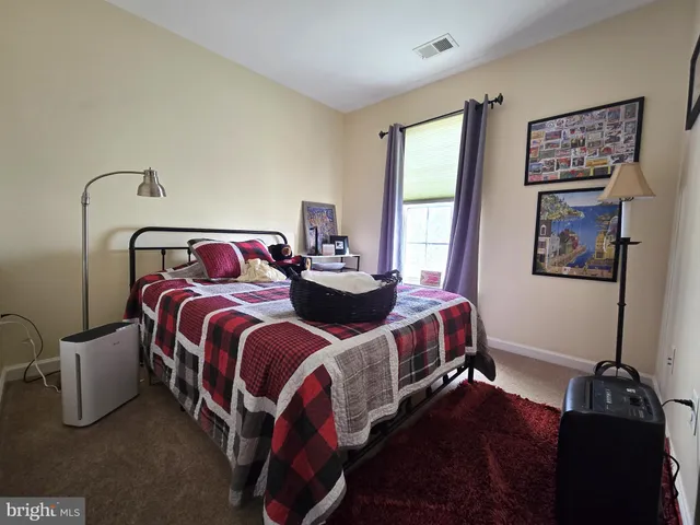 a bedroom with bed and window