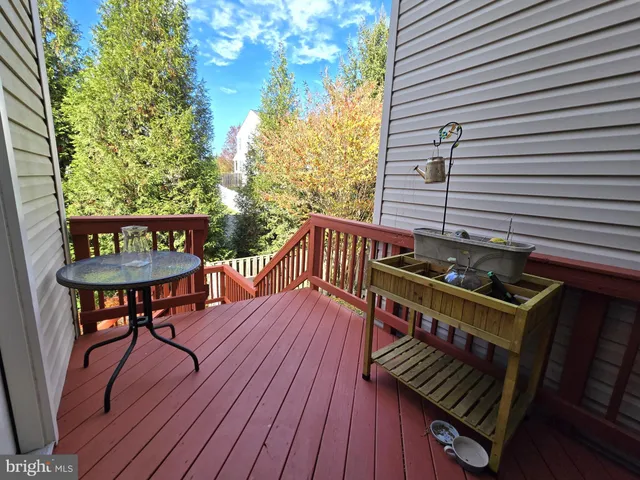 a view of a deck with chairs and wooden floor