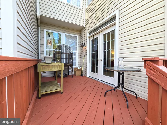 a view of a roof deck with wooden floor and fence