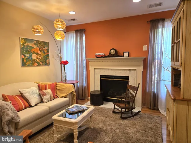a living room with furniture a rug and a fireplace