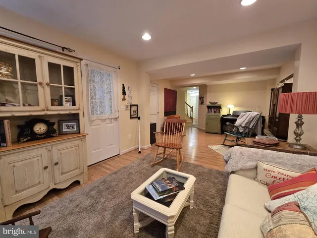 a living room with furniture a rug and a window