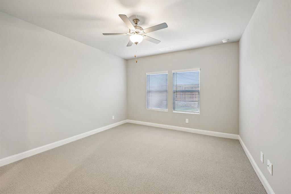 1721 Arches Road Anna, TX 75409 - Photo 22 of 39 an empty room with window and ceiling fan