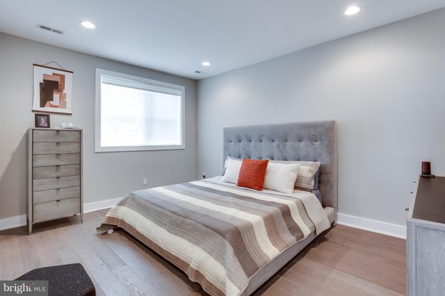 a bed sitting in a bedroom next to a window