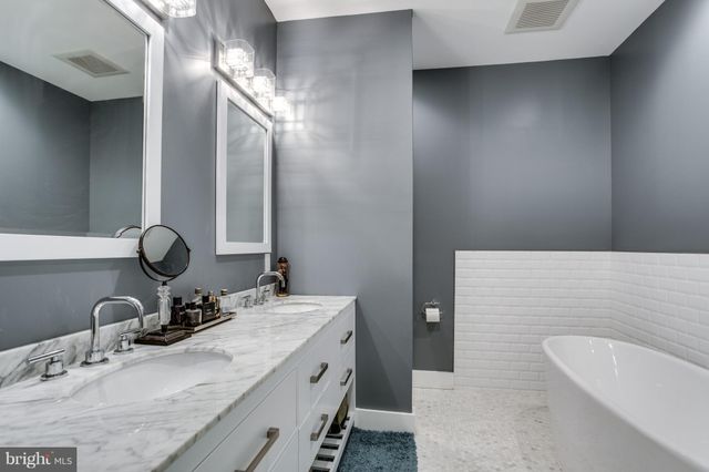 a bathroom with a double vanity sink and a mirror