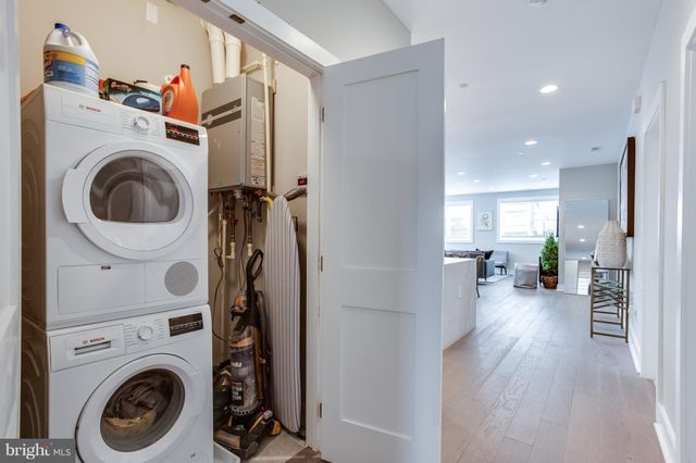 a view of a hallway with washer and dryer