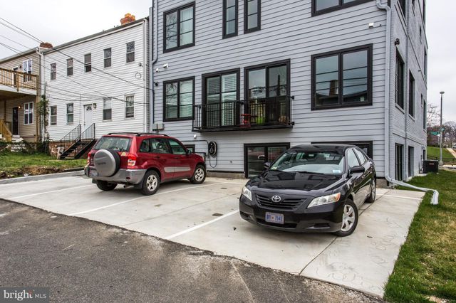 a car parked in front of a brick house