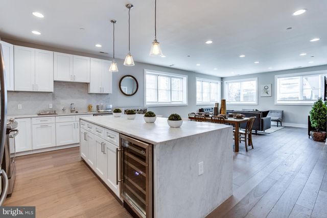 a kitchen with a sink cabinets and wooden floor