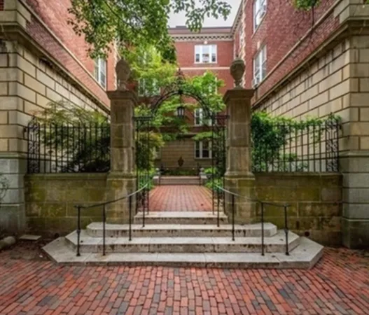 a view of fountain along with brick wall