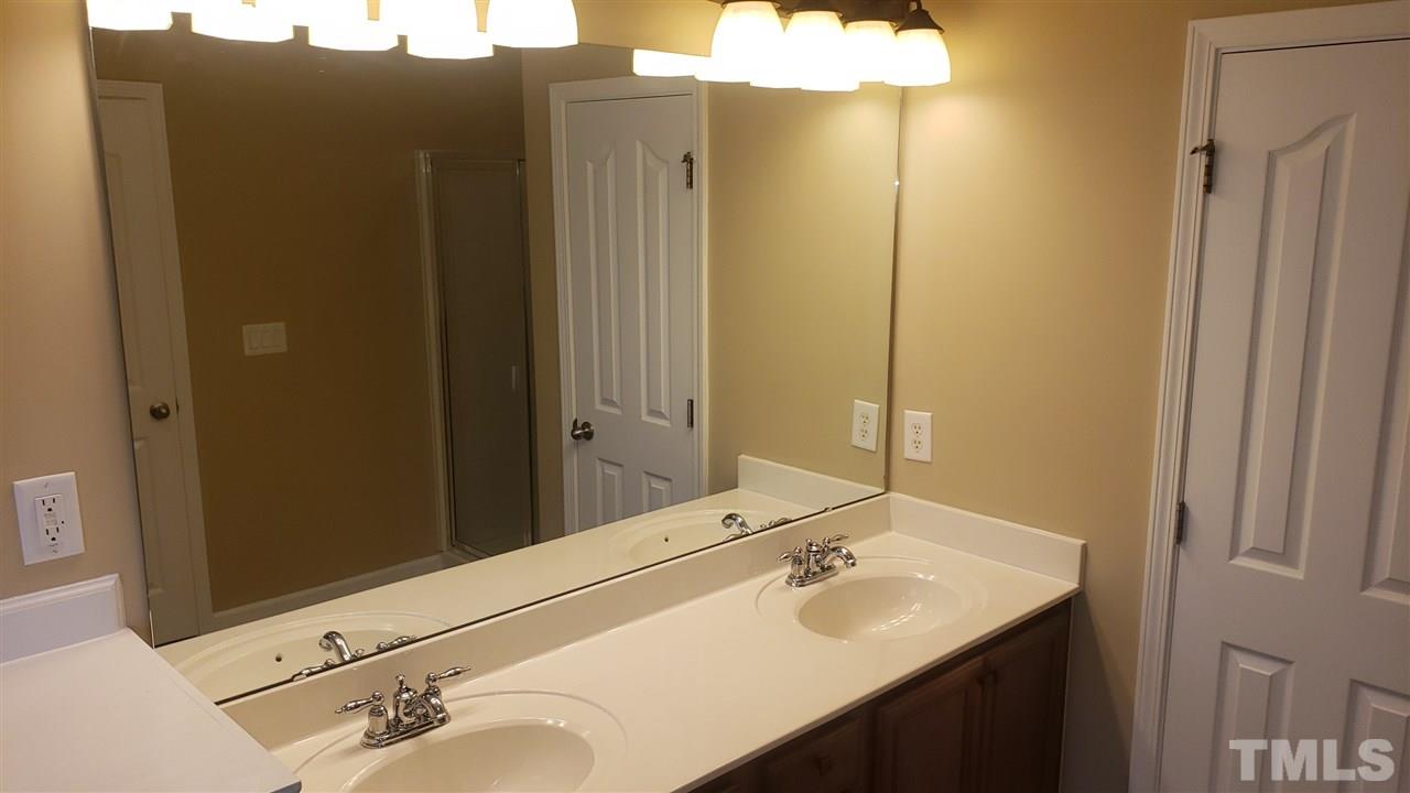 9708 Renfield Drive Raleigh, NC 27617 - Photo 18 of 24 a bathroom with a sink and a mirror