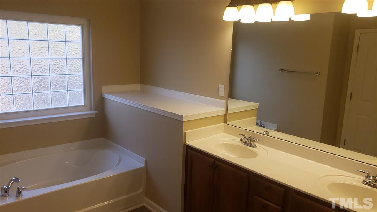 9708 Renfield Drive Raleigh, NC 27617 - Photo 19 of 24 a bathroom with a sink and a bathtub