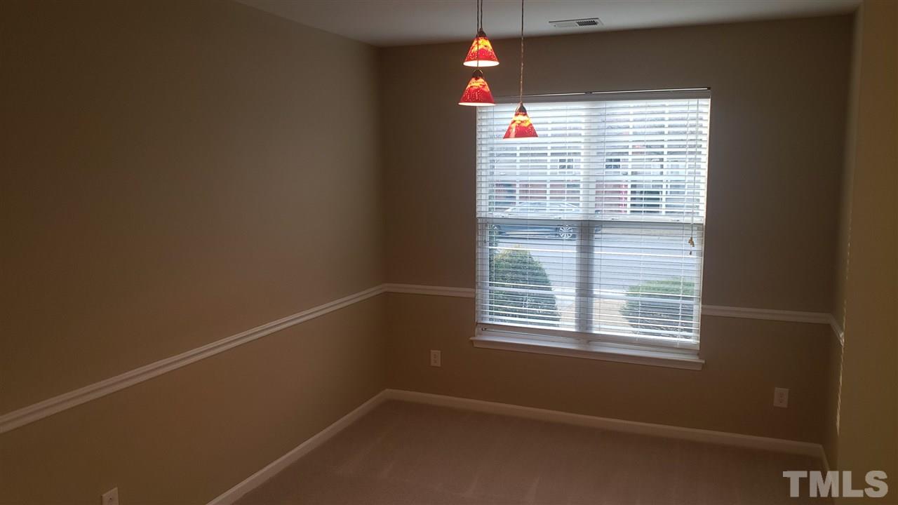 9708 Renfield Drive Raleigh, NC 27617 - Photo 5 of 24 a view of an empty room with a window