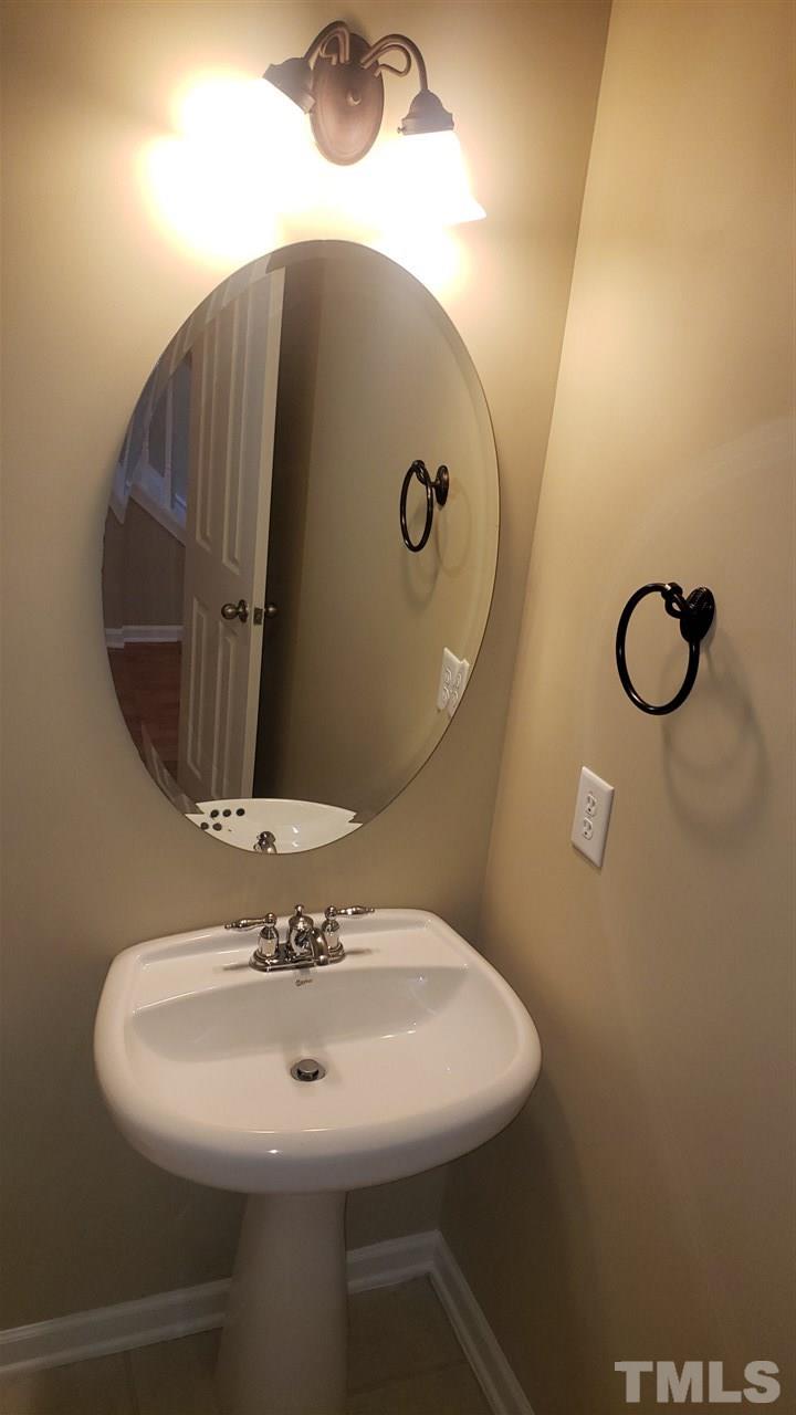 9708 Renfield Drive Raleigh, NC 27617 - Photo 6 of 24 a bathroom with a sink and mirror
