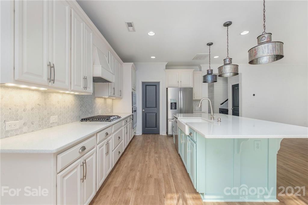 120 Helton Lane Fort Mill, SC 29708 - Photo 4 of 21 a kitchen with stainless steel appliances granite countertop a sink a stove and a refrigerator