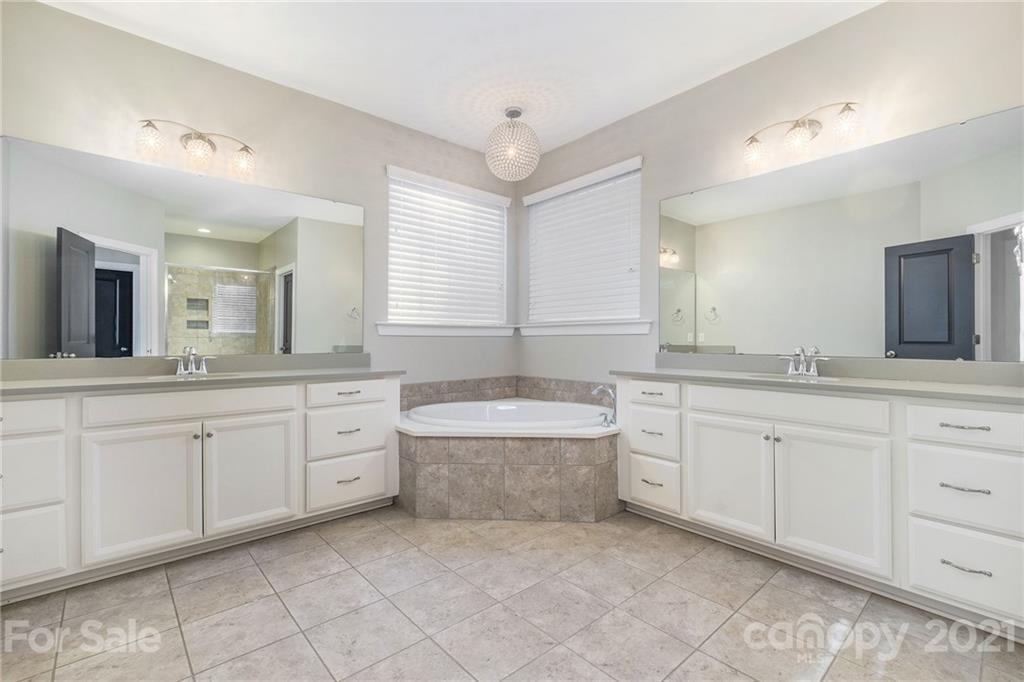 120 Helton Lane Fort Mill, SC 29708 - Photo 6 of 21 a spacious bathroom with a granite countertop sink mirror and bathtub