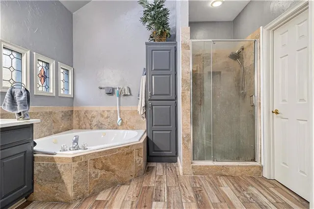 a bathroom with a tub and shower