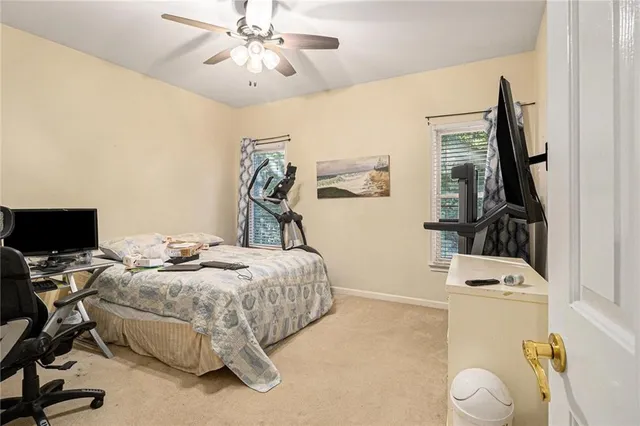 a bedroom with bed and a flat tv screen