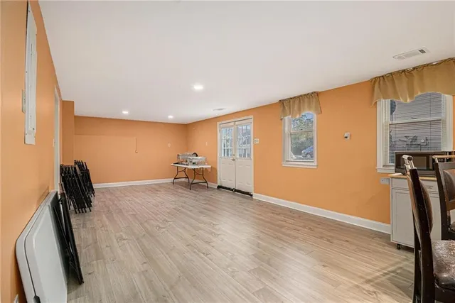 a view of a livingroom with a hall and wooden floor