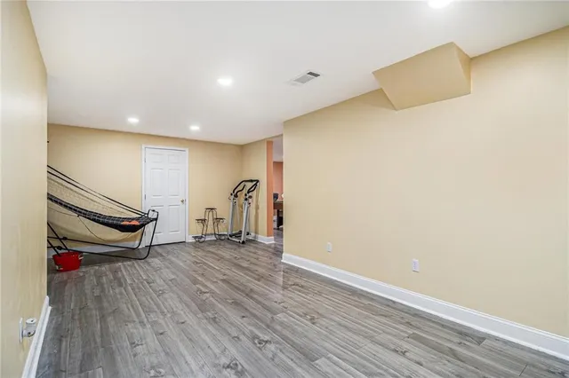 a view of a room with wooden floor and window