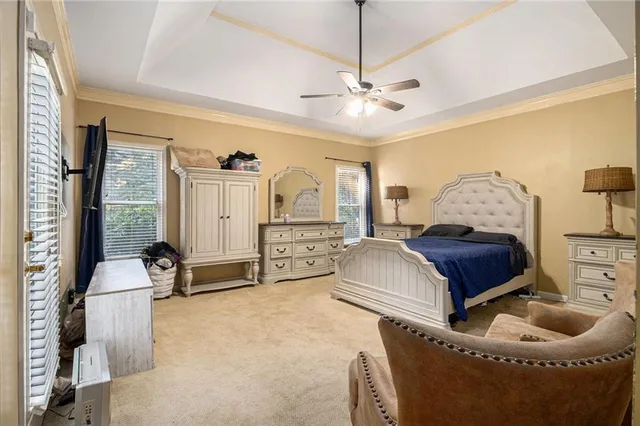 a spacious bedroom with a bed and ceiling fan
