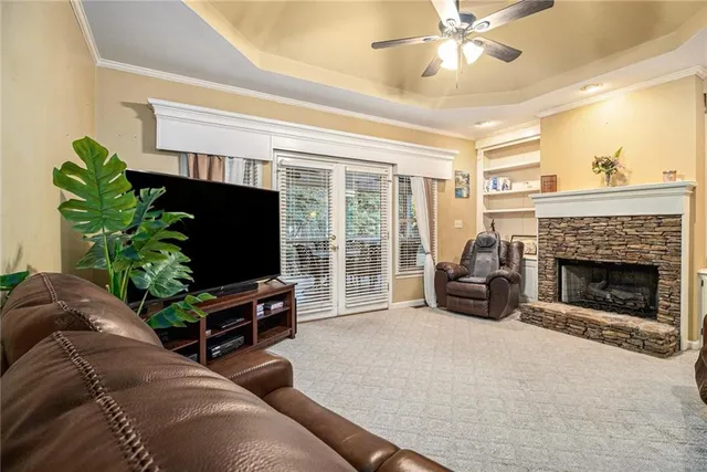a living room with furniture a fireplace and a flat screen tv