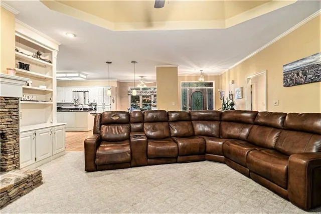 a living room with furniture wooden floor and kitchen view