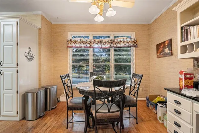 a view of a dining room with furniture a chandelier and wooden floor
