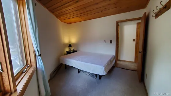 a room with a bed and a mirror