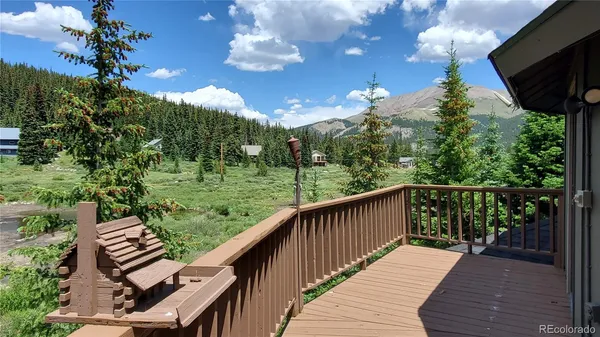 a balcony with wooden floor and outdoor space