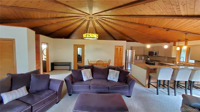 a dining room with furniture and a umbrella