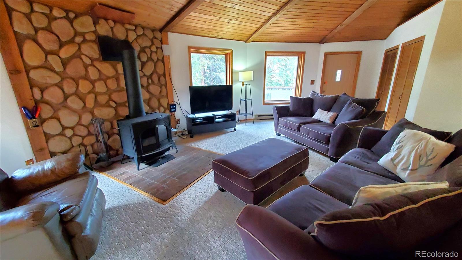 92 Scr 855 Breckenridge, CO 80424 - Photo 23 of 28 a living room with furniture a flat screen tv and a fireplace