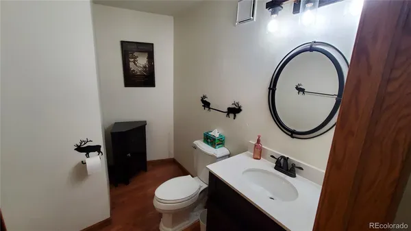 a bathroom with a sink toilet and a mirror