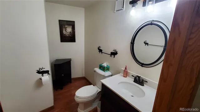 a bathroom with a sink toilet and a mirror