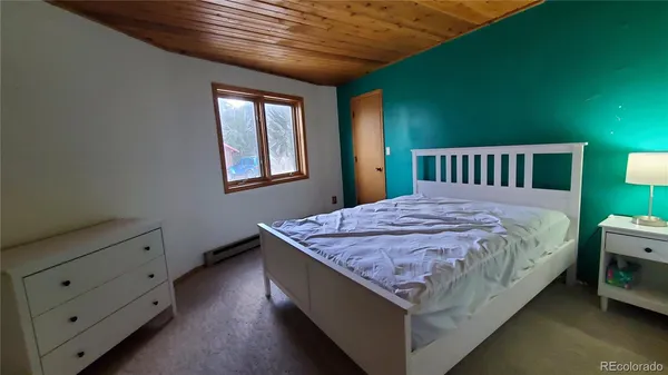 a bed sitting in a bedroom next to a window