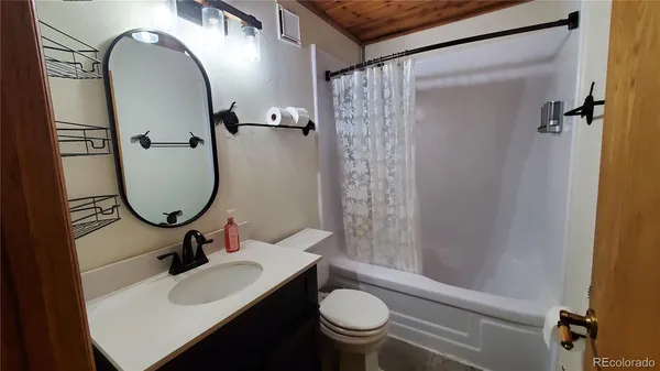 a bathroom with a sink toilet and a mirror