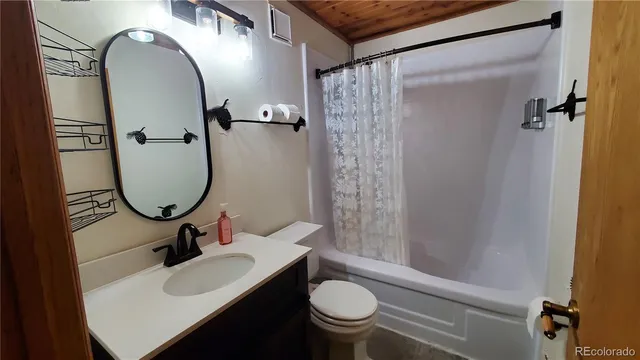 a bathroom with a sink toilet and a mirror
