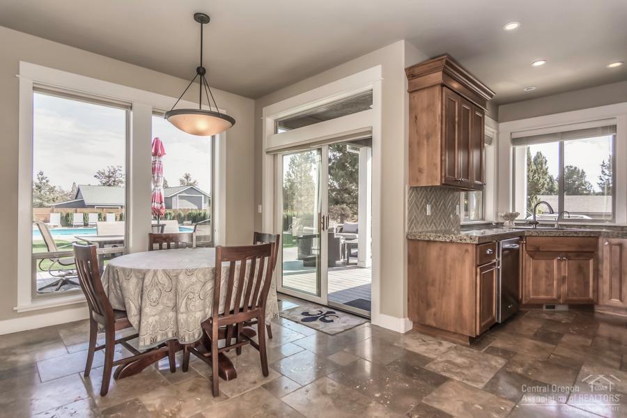 63528 Old Deschutes Road Bend, OR 97701 - Photo 10 of 25 a view of a dining room with furniture large windows and wooden floor