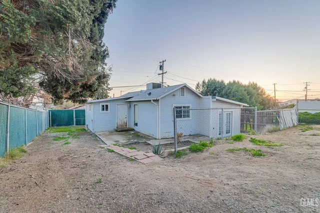 a view of a dirt road and a building