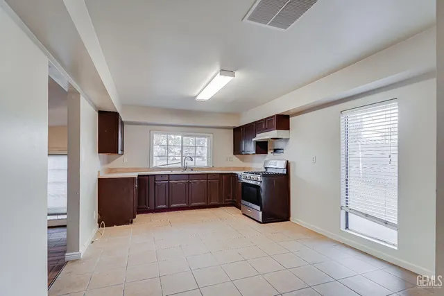 a kitchen with stainless steel appliances granite countertop a stove microwave and sink