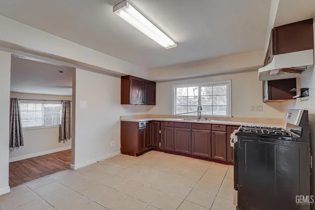 a kitchen with stainless steel appliances a stove sink and cabinets