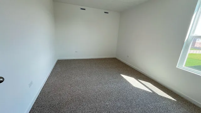 an empty room with a empty space and a window