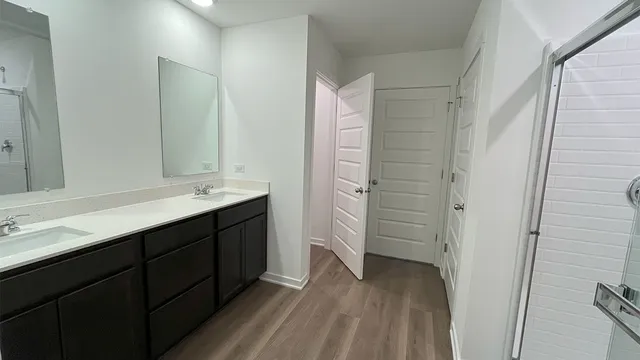 a bathroom with a double vanity sink a and mirror