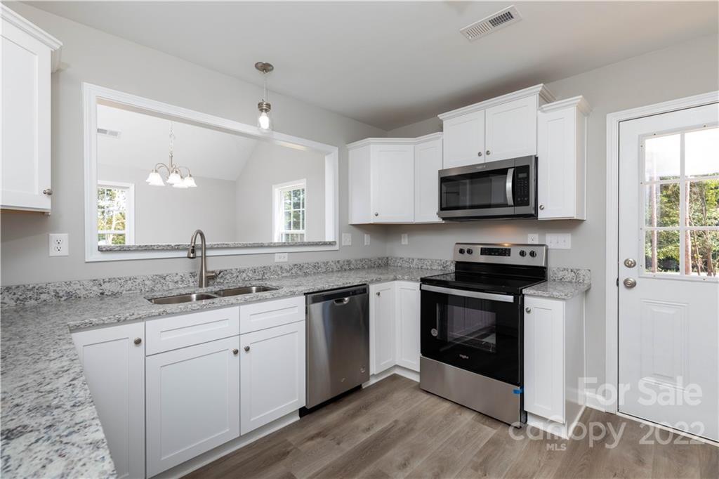 6184 Hopewell Road Hickory Grove, SC 29717 - Photo 20 of 30 a kitchen with a sink stove and microwave