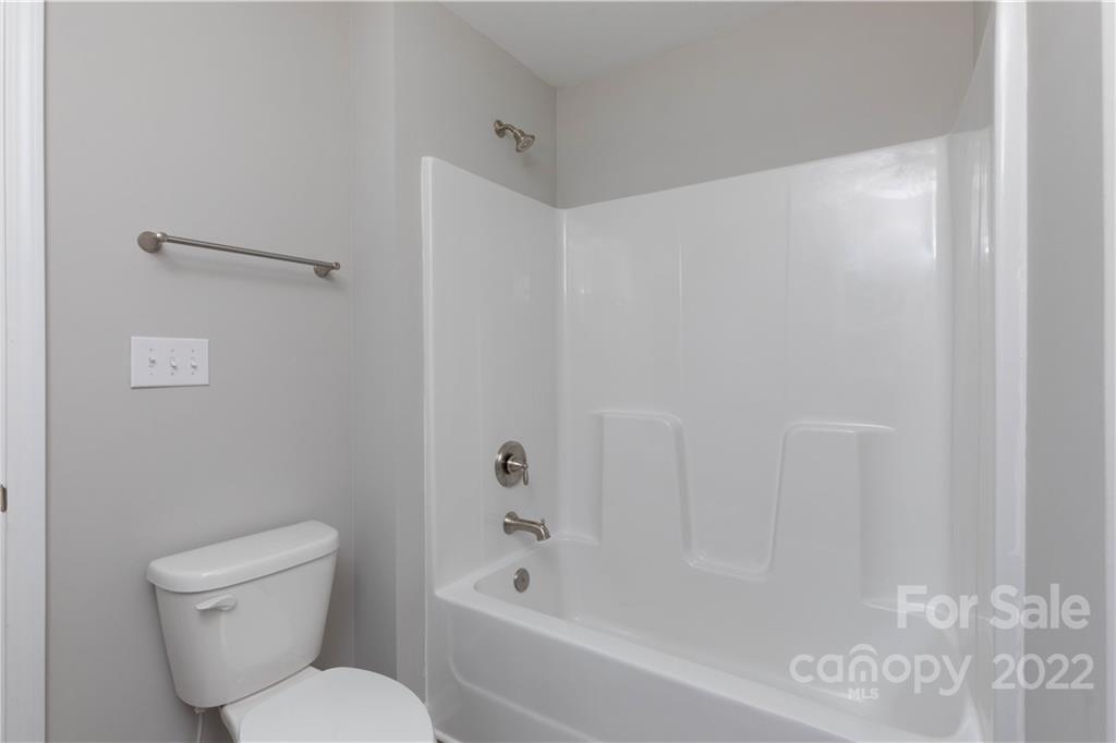 6184 Hopewell Road Hickory Grove, SC 29717 - Photo 26 of 30 a bathroom with a toilet and a bathtub