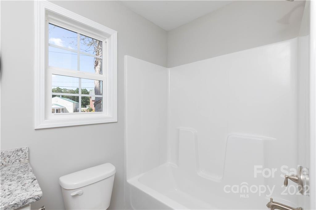 6184 Hopewell Road Hickory Grove, SC 29717 - Photo 29 of 30 a white toilet sitting next to a bathroom sink